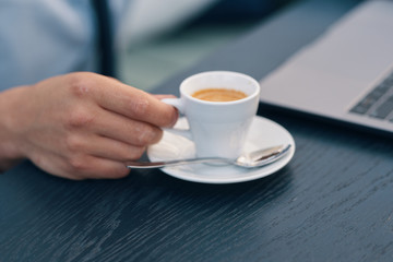 man holding cup of coffee in hand