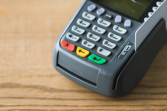 close up of credit card reader on wooden table