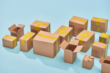 postal cardboard boxes on blue background with copy space