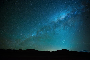 The milky way shining in the Siloli desert at high altitude in the Andes mountain range of Bolivia...