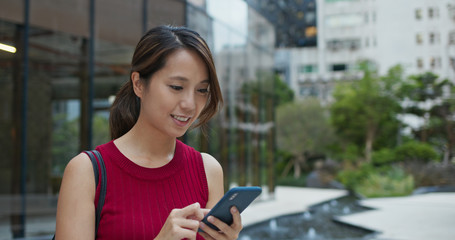 Woman use of mobile phone at street