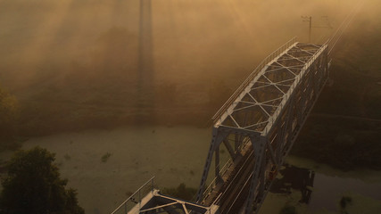 Drone view Double railway bridge over river in morning fog