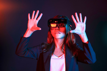 Business woman try vr glasses hololens in the lab room. Mixed reality future technology concept