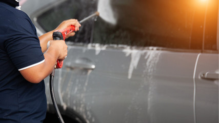 Washing car with soap. Close up concept.