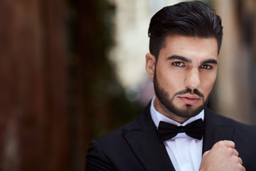 Businessman with james bond dress in little street in Rome