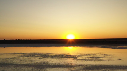 Drone wiev Orange dawn over foggy lake. the sky is well reflected in the water