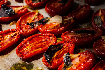 Dried tomatoes with garlic, Basil and salt on parchment paper