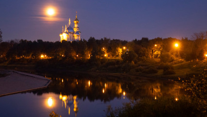 Fototapeta na wymiar St. Sophia Cathedral and bell tower at night, against a full moon.