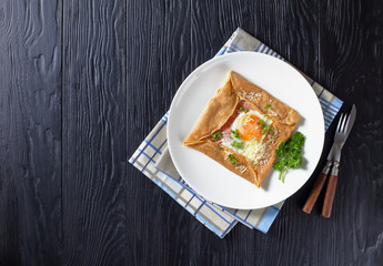 Breton crepe on a white plate, top view
