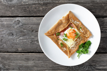 Breton crepe with egg on a white plate