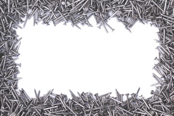 Steel nails laid out in the form of a frame with a place under the text. A pile of sharp nails on a white isolated background with copy space.