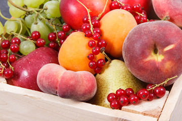 Heap of fruits in wooden box as healthy snack or dessert containing natural vitamins