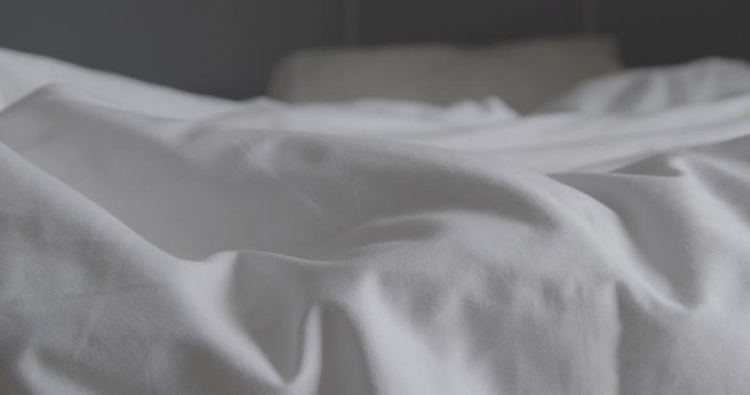 Crumpled messy white blanket untidy, Unmade bed after waking up in the morning with a duvet on the bed.