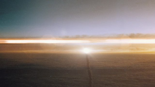 Space Rocket Launching into Space Through the Clouds at Sunset