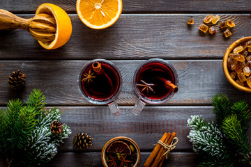 New Year composition with mulled wine and fir branches on dark wooden background top view