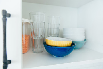 Various seeds in storage jars in pantry, white modern kitchen in background. Smart kitchen organization. Healthy cooking, clean eating concept.