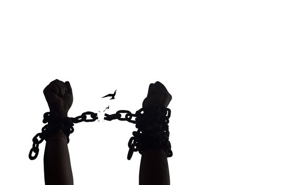 International day for the remembrance of the slave trade and its abolition concept: Silhouette human hands raising and broken chains isolated on white background