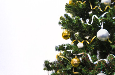 Christmas decoration. Isolated on white background. Christmas tree decorated with yellow and white balls and tinsel