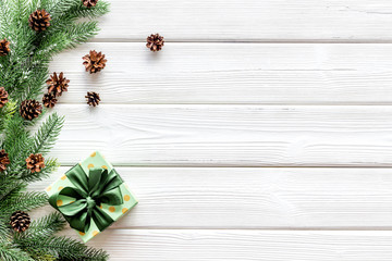 Presents for christmas in boxes and spruce frame on white wooden background top veiw copyspace