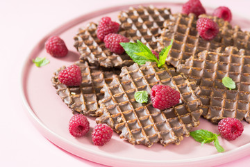 Waffles with chocolate on a pink plate