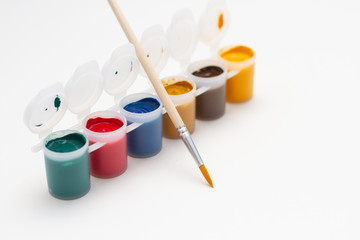 Fototapeta na wymiar multicolored gouache and paint brush