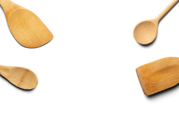 Wooden spoons and stirrers. Isolated on white background. Top view.