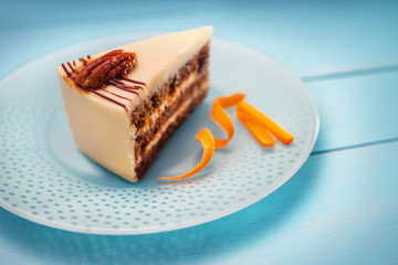 Cake piece with chocolate, milk cream, carrots and nuts isolated