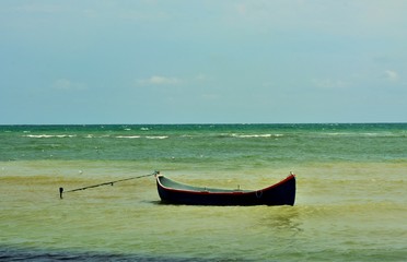 a boat anchored at the seashore