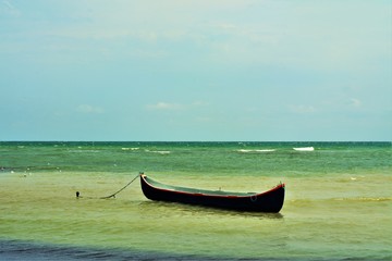 a boat anchored at the seashore