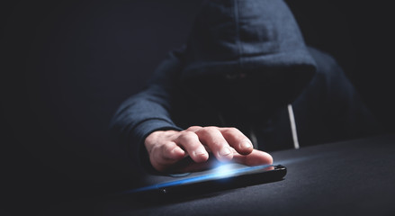 Hacker with smartphone. Cyber crime