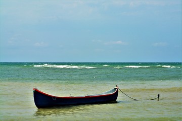 a boat anchored at the seashore