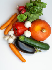 Pumpkin, eggplant, carrots, mushrooms, pepper, radish and courgette on white background