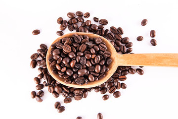 Coffee bean in spoon on white background