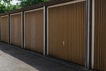 Brown wooden garage doors on a sunny day