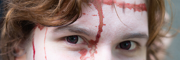 Banner of the eyes of young woman with blood in her face