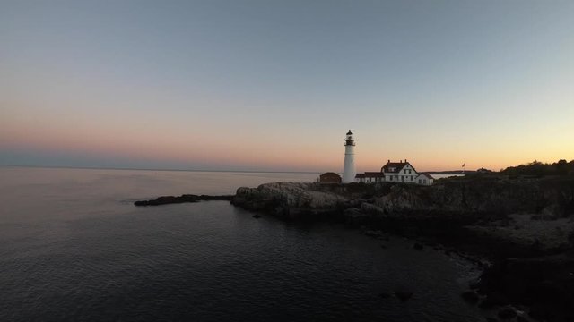 Aerial 4K Video of Portland Head Lighthouse, Maine at sunset. Drone shot moving forward.