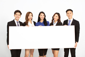 business people standing and holding blank board