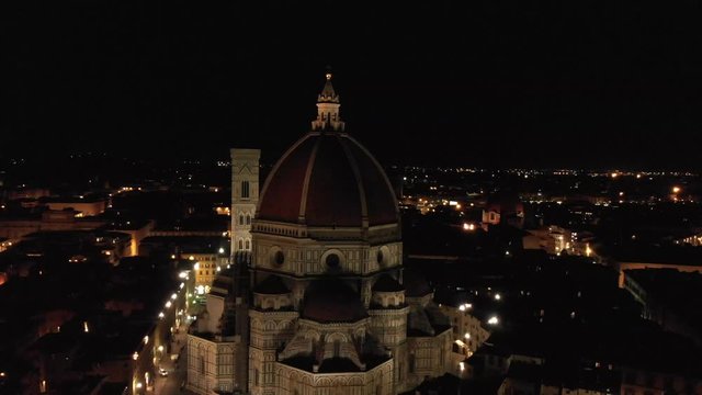 In Florence Italy, this night drone flight focuses on the Duomo and flies to the right as it slowly pans to the left.