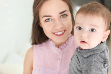 Loving mother with her baby on light background