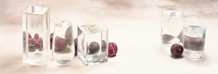 Foods distorted through liquid and glass on light background.