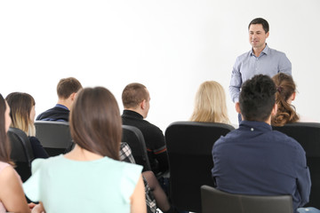 Group of people with business trainer at management seminar