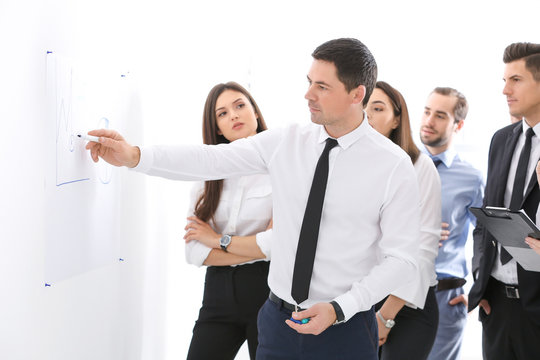 Group of people with business trainer at management seminar