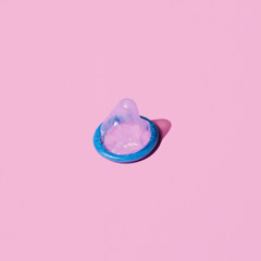 High angle blue condom on pink background