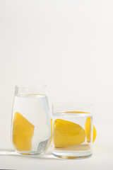 Foods distorted through liquid and glass on white background.