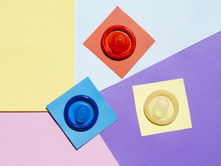 Flat lay condoms on colourful background