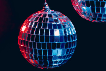 Sparkling disco balls hanging in the air against black background