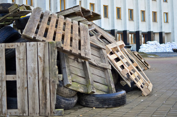 Barricades in the city constructed of old wooden pallets and tires.