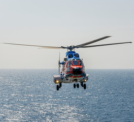 Fototapeta na wymiar helicopter flying over the sea