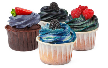 Group of cupcakes with colored topping isolated on white background