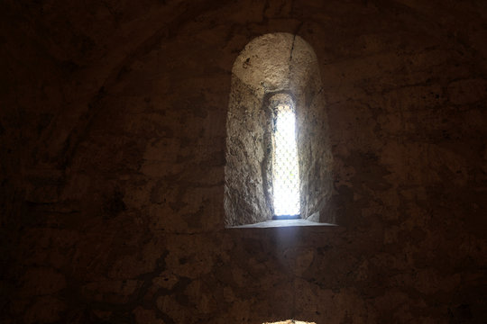 Window in the wall of an ancient Albanian temple in the village of Kish, the city of Sheki